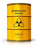 A gold-colored 55 gallon steel drum with the words 'Radioactive Waste' stenciled in black on the top third of the drum, and a black trefoil symbol, long accepted as the label for denoting radioactive material -- in the middle section of the drums exterior