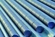 Ceramic fuel pellets in trays; grey, cylindrical pellets laying side by side in fitted trays